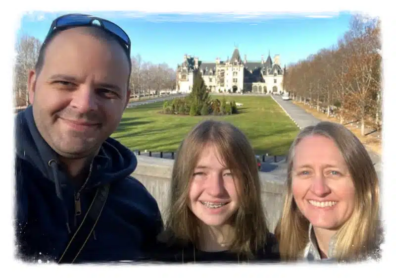 Family posing in front of Biltmore Estate gardens.